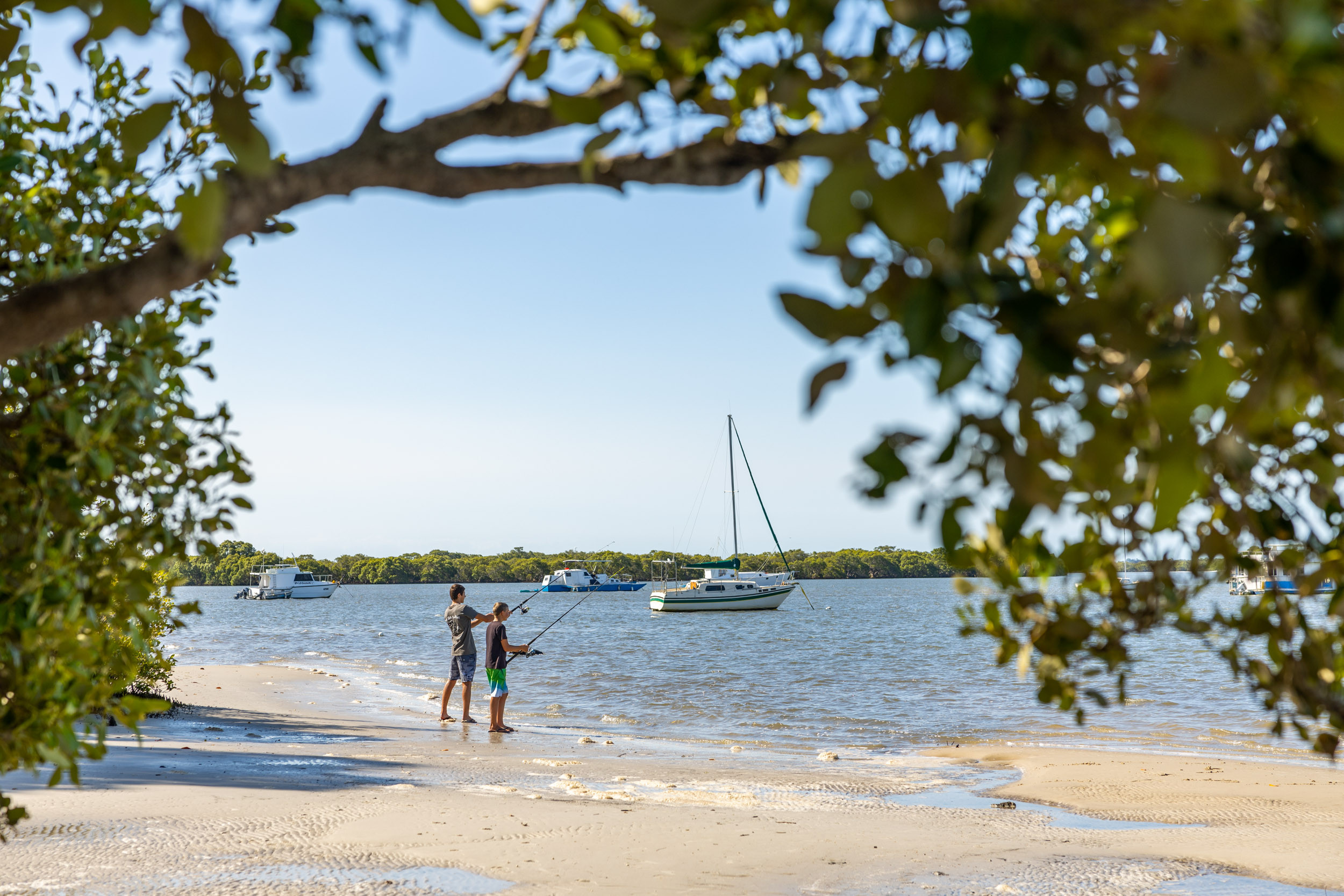 Two boys fishing on the foreshore at Jacobs Well.