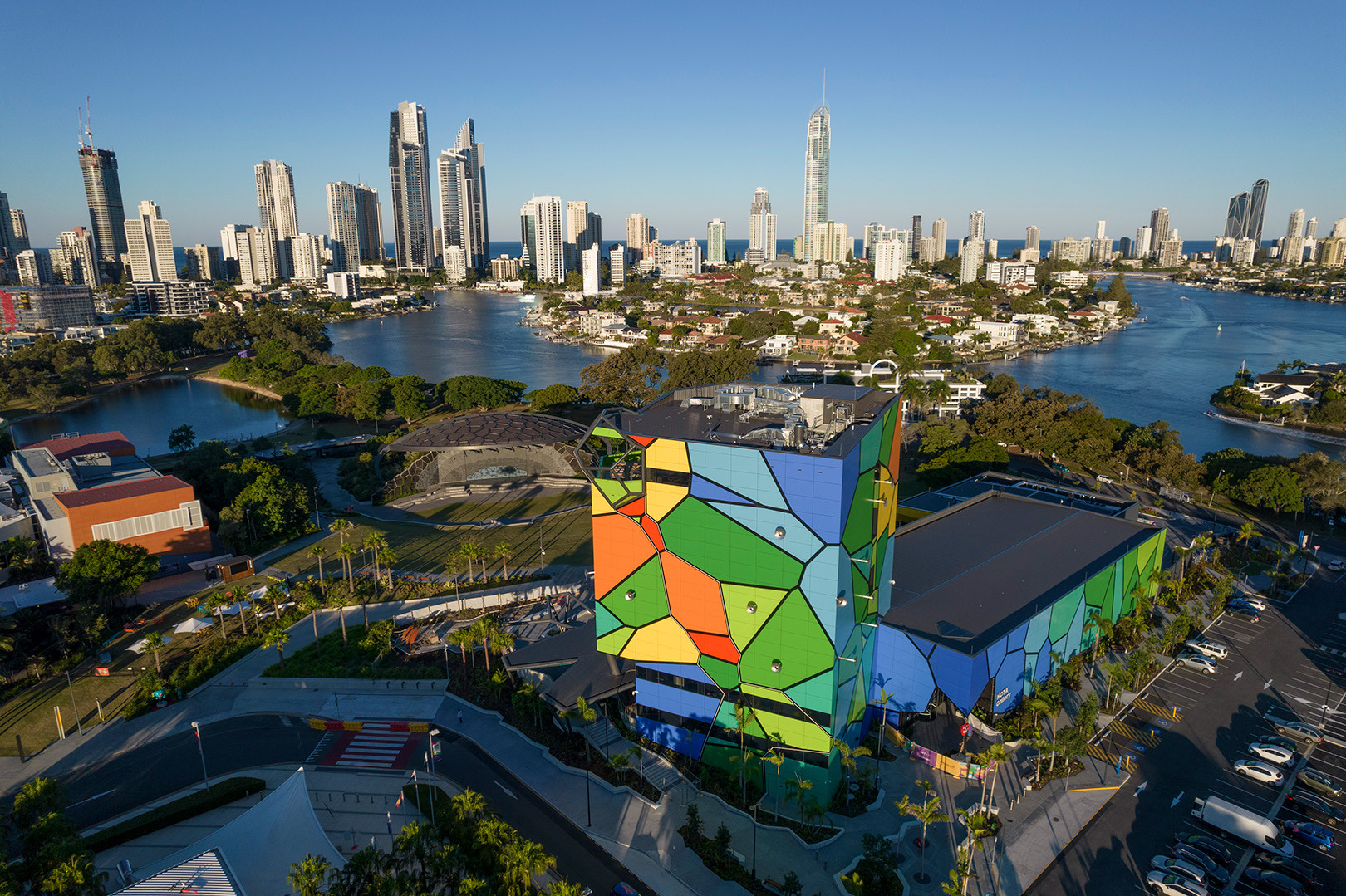 Aerial view of HOTA gallery, outdoor cinema and lawn, Evandale Lake, and the Surfers Paradise skyline in the background.