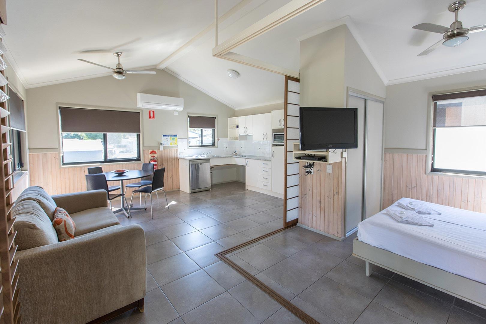 The Accessible Cabin at Burleigh Beach Tourist Park. The bedroom opens up to the open plan living, kitchen and dining area.