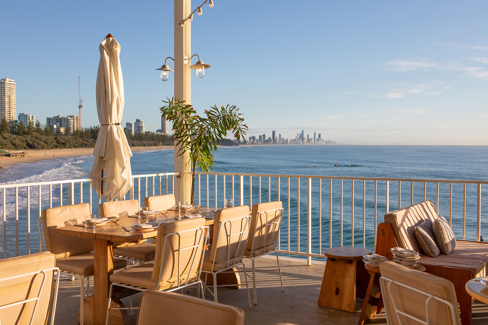 The dining terrace at The Tropic Restaurant in Burleigh Heads. The view from the terrace is Burleigh Beach and the Gold Coast skyline.